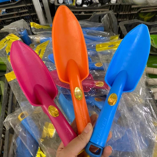 Small potting or garden shovel. Made of compressed plastic.